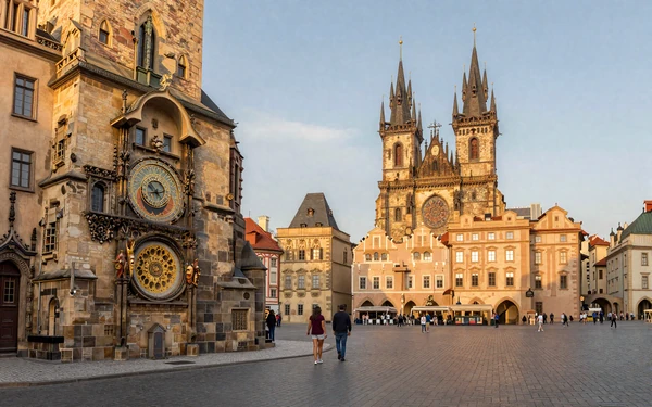 Prague Old Town Square at golden hour with the Astronomical Clock and Tyn Church creating a romantic backdrop